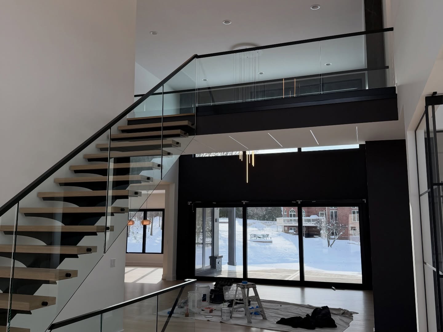 Modern open-concept remodel with floating staircase and glass railing