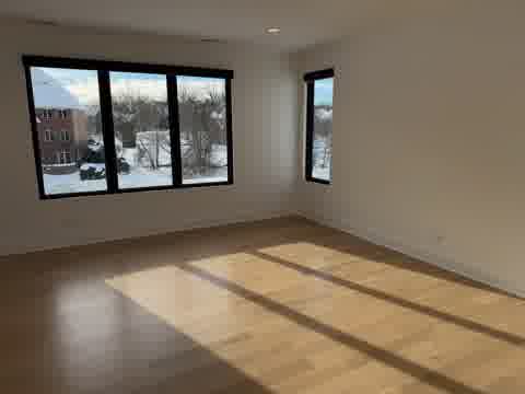 Sunlit bedroom with pristine walls in Burr Ridge