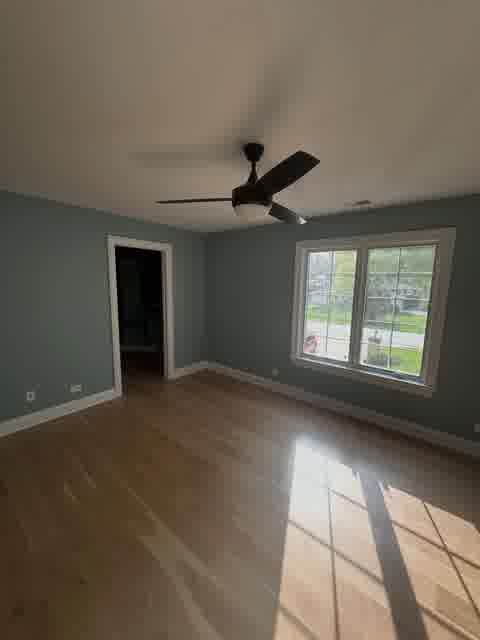 Bedroom with steel-blue walls, ceiling fan, hardwood floors and walk-in closet, Bloomingdale