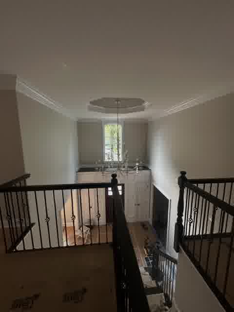 Two-story foyer with chandelier and wainscoting mid-project, Bloomingdale