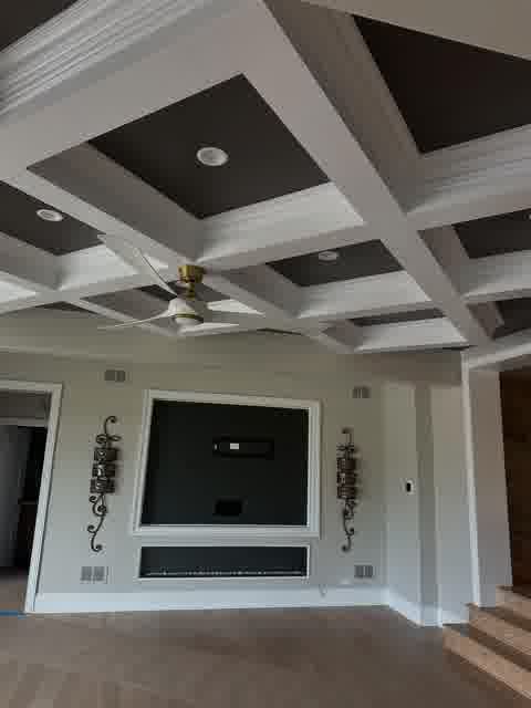 Coffered ceiling with dark panels, linear fireplace and iron sconces, Bloomingdale