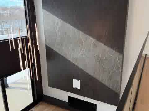 Floor-to-ceiling marble fireplace wall with modern pendant lights, Burr Ridge