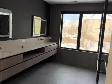 Dark bathroom with floating dual vanity, LED backlit mirrors and charcoal walls, Burr Ridge