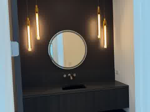 Luxury bathroom vanity with round mirror and gold pendant lights, Burr Ridge