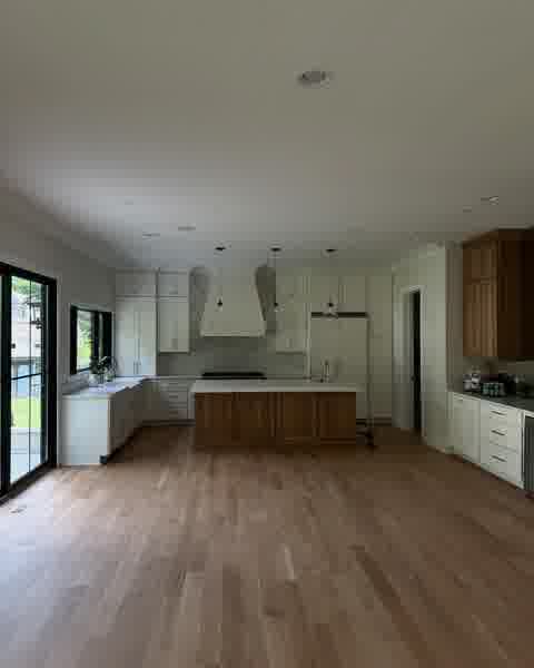 White kitchen with marble backsplash, range hood and wood island, Clarendon Hills