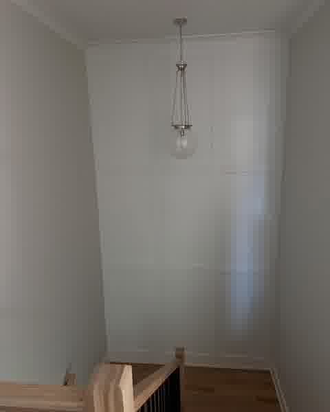 Stairwell with panel moulding accent wall and globe pendant light, Clarendon Hills