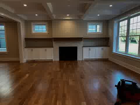 Living room with coffered ceiling, herringbone tile fireplace and walnut floating shelves, Elmhurst