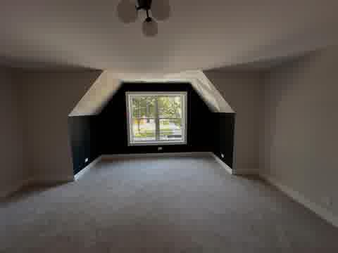 Attic bedroom with dark navy accent wall and light gray side walls, two-tone paint finish, Elmhurst