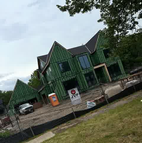 Large new construction with JVP Drywall Solutions sign on site, Hinsdale