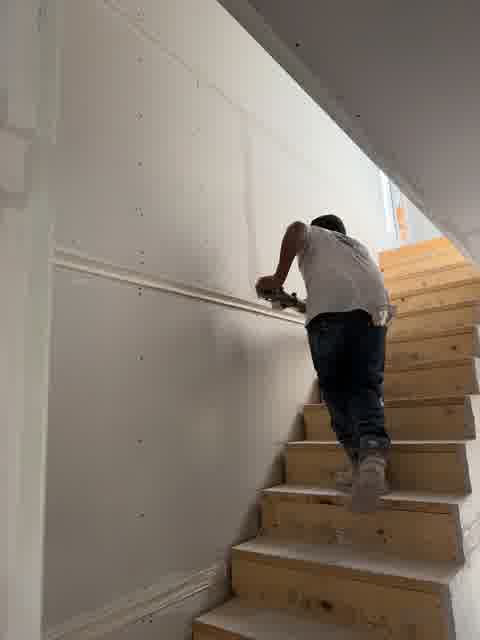 Drywall taping in progress on staircase, Northbrook