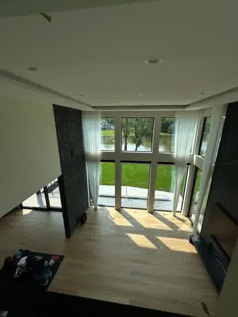 Great room from above with tray ceiling, stone column and lake view, Oak Brook