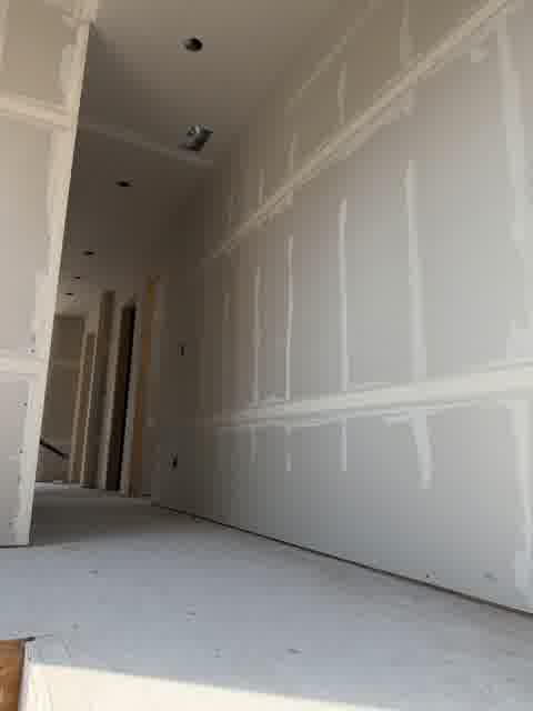 Finished drywall taping and mudding in a residential hallway