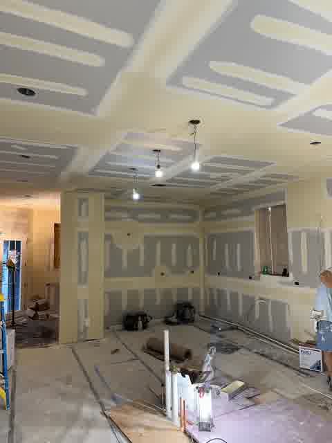 Drywall seams being taped and mudded in new construction